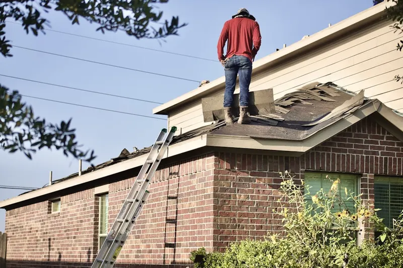Professional roofer working on a residential roof in Savan